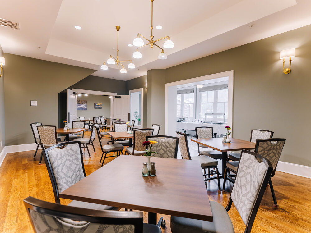 The Carroll Banquet Room at The Inn at Foster Falls — dining tables opening to a sunroom